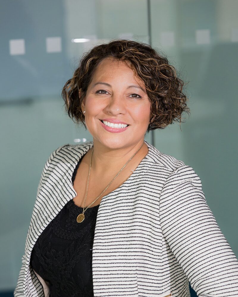 Sales professional smiling during a recruitment screening conversation