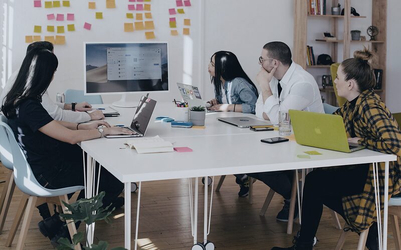 Marketing team planning a campaign around a shared table