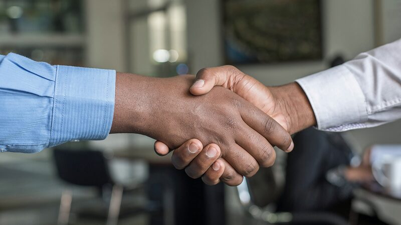 Employer and new hire shaking hands after an accepted offer